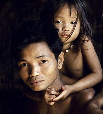 Indonesia. Borneo rain forest. Dyak manand daughter.