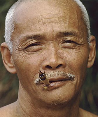 Malaysia. Sabah. Bajau fisherman. Smokes a cigarette he himself rolled.